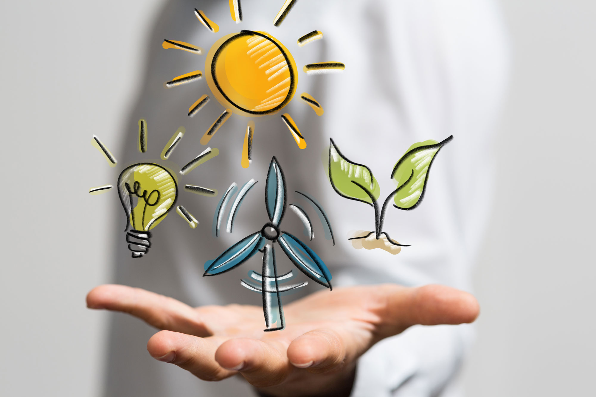 Über einer ausgestreckten Hand stehen gezeichnet Sonne, Windrad, Glühbirne und Pflanze – symbolisch für den Ausbau nachhaltiger erneuerbarer Energien.